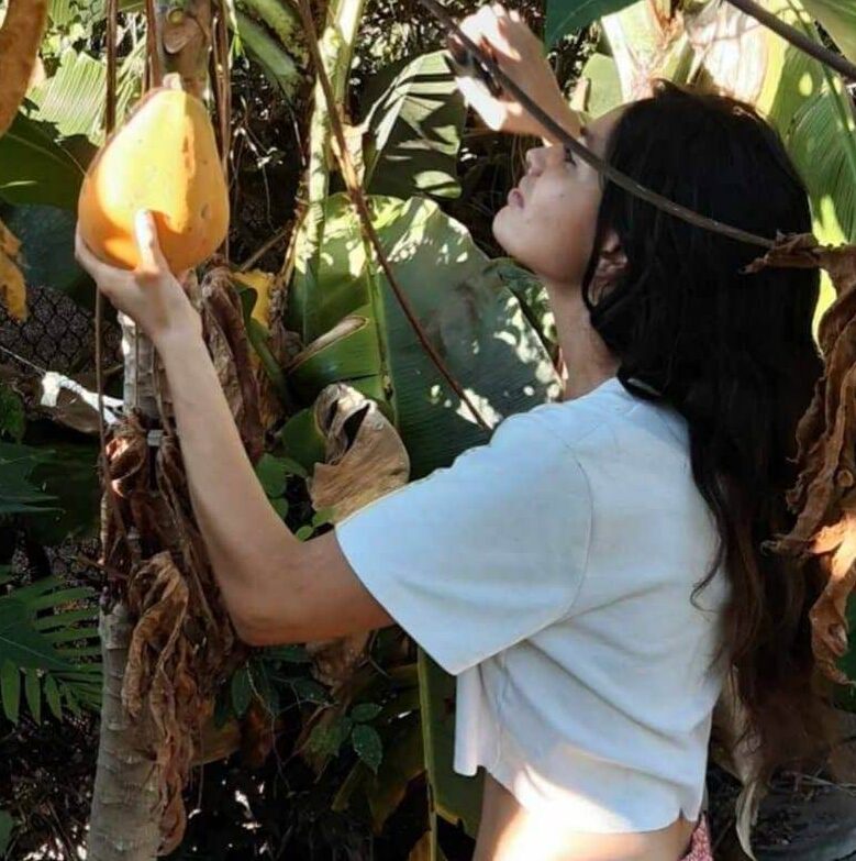 Maria-picking-papaya-connecting-mother-earth