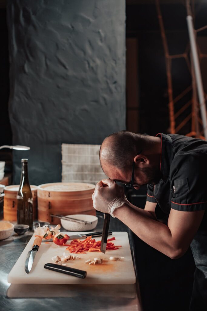 A Weary Chef Leaning on the Chopping Board - overworking hospitality